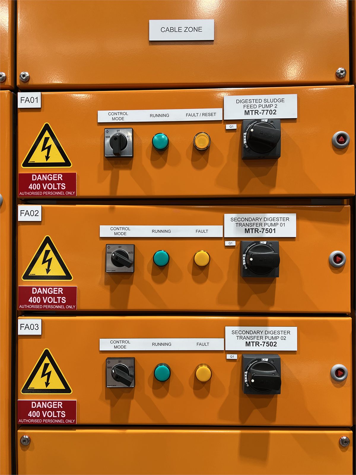 Close-up of motor control centre switches and indicator lights