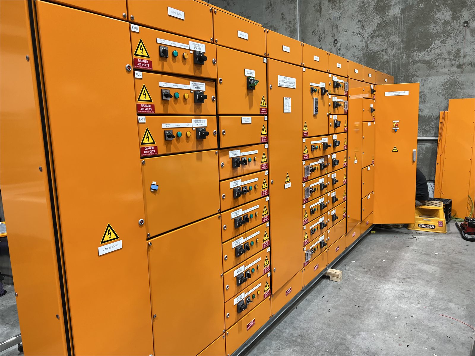 Angled view of a completed orange motor control centre